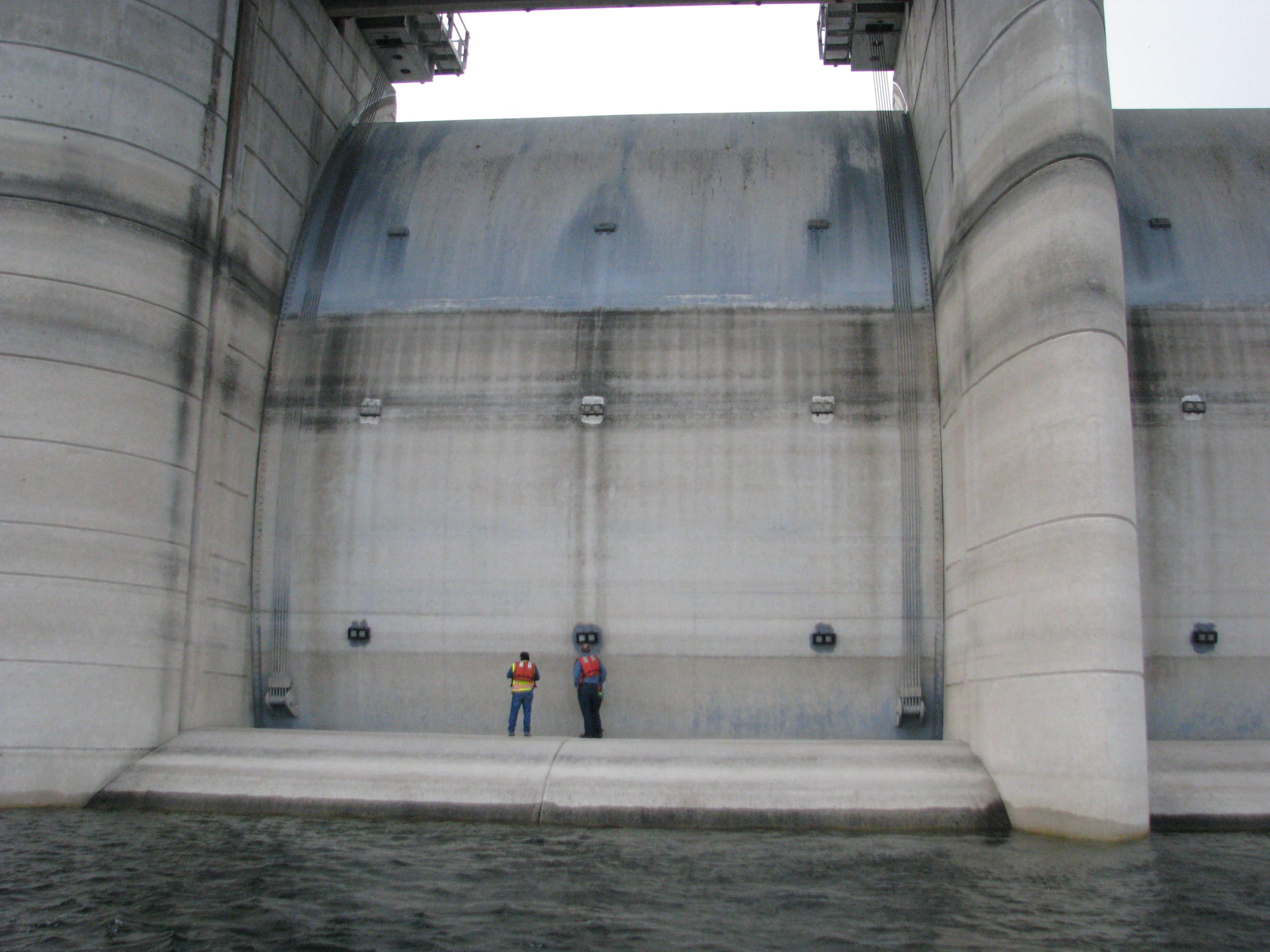 Fifty two foot tainter gates on Amistad Dam viewed from reservoir in 2014