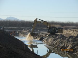 Excavating the new river channel as part of the construction of a new levee segment in Vado, NM in 2016