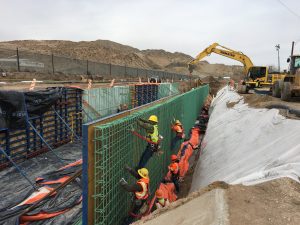 Workers typing rebar for new 24 ft wide, 12 ft tall U-channel on the Upper Reach of the American Canal